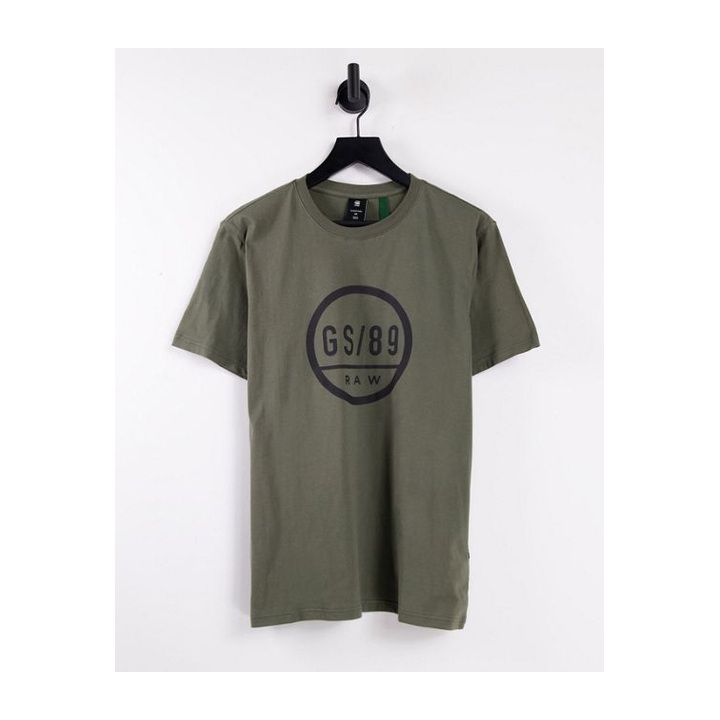 Olive crewneck with a dark circular chest emblem.
